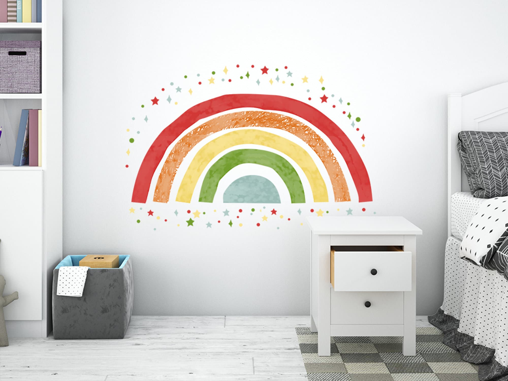 Watercolor style rainbow wall decal in red, yellow, and green with scattered star stickers on a white wall in a child's bedroom