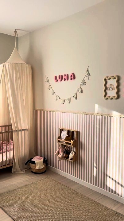 Striped half wall wallpaper in a real nursery