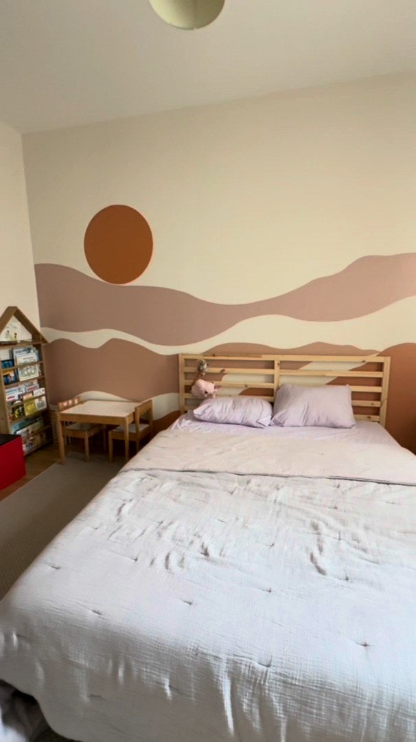 Terracotta boho sun and abstract mountain wall decal above a bed