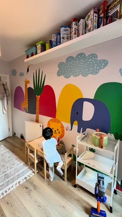 Colorful animal wall mural in a real playroom